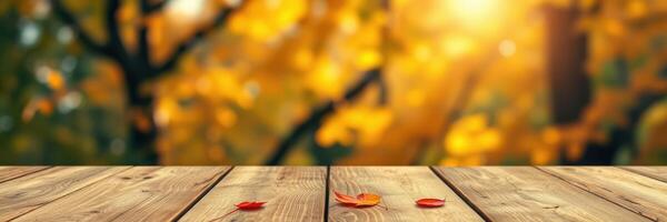 Autumn leaves scattered on a wooden table under warm sunlight in a park setting photo