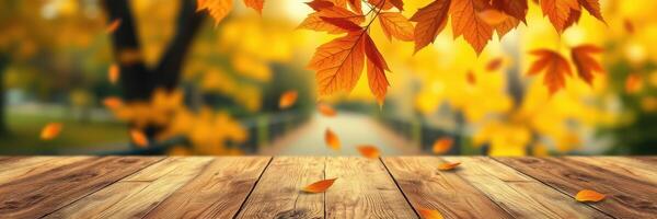 Vibrant autumn leaves fall onto a rustic wooden table in a serene park setting on a sunny day photo