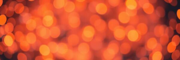 Warm glow of shimmering orange lights filling the background during a festive gathering in the evening photo