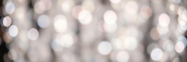 Soft bokeh lights create a dreamy atmosphere in a festive indoor setting during evening hours photo