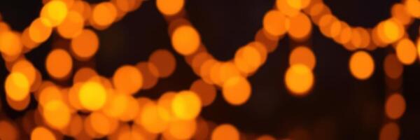 Warm glowing lights create a cozy atmosphere during a festive evening gathering in a backyard setting photo