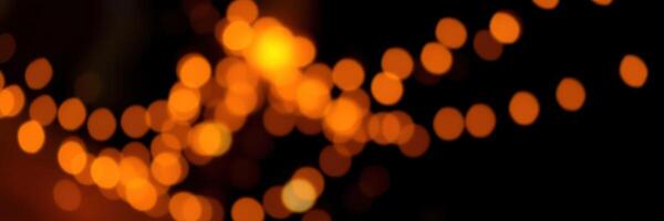 Warm glowing lights illuminate the night creating a festive atmosphere at an outdoor event photo