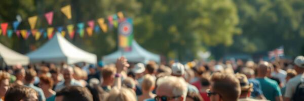 Crowd gathering at a vibrant outdoor festival with colorful decorations and tents in a sunny park photo