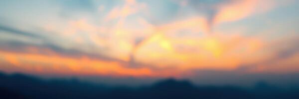 Beautiful sunset with vibrant colors over mountain landscape in the evening sky photo