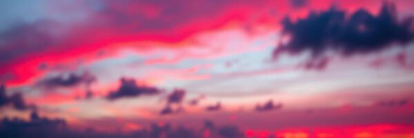 Vibrant sunset over the ocean with swirling clouds reflecting warm colors in the evening sky photo