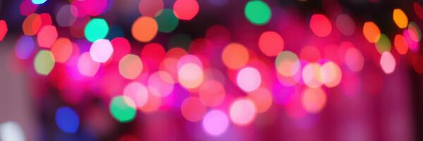 Colorful bokeh lights create a festive atmosphere in a vibrant setting during a celebration at night photo