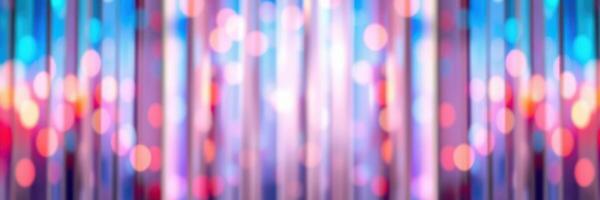 Vibrant light patterns create an abstract background of colorful bokeh effects at a nighttime event photo
