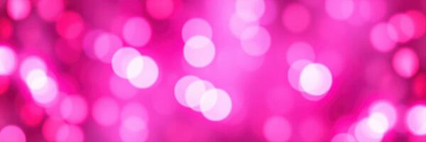 Bright pink bokeh lights create a festive atmosphere in the event space during the evening celebration photo