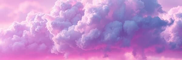 Soft pink clouds fill the sky at sunset over a tranquil landscape with vibrant hues illuminating the horizon photo