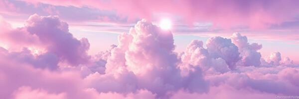 Sunset casts soft pink hues across fluffy clouds in a serene evening sky above the horizon photo