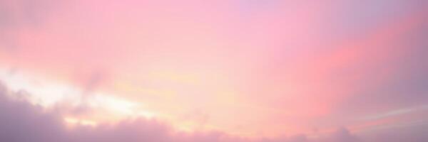Sunset colors paint the sky over gentle clouds in a serene evening atmosphere photo