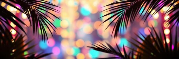Colorful lights shine through palm leaves during a festive evening gathering in a tropical location photo