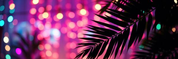 Festive lights twinkle against tropical leaves in a vibrant indoor setting during an evening gathering photo