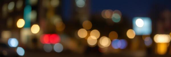 City night lights create a vibrant bokeh effect with blurred buildings and illuminated signs on a bustling street photo