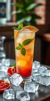 Refreshing cocktail garnished with mint leaves and orange slice served over ice in a bright bar setting photo