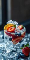 Refreshing summer fruit cocktail with strawberries, blueberries, and lemon over ice photo