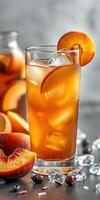 Refreshing peach iced tea served in a tall glass with fresh fruit and ice cubes on a wooden table photo