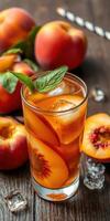 Refreshing peach iced tea garnished with mint and served with fresh peaches on a wooden table photo