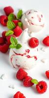 Delightful meringue desserts topped with fresh raspberries and mint leaves on a white background photo