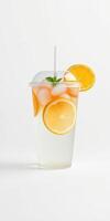 Refreshing citrus beverage with ice and mint served in a clear cup photo
