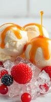 Delicious ice cream scoops topped with caramel and fresh berries on ice photo