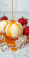 Delicious vanilla ice cream topped with caramel syrup and fresh strawberries on a marble countertop photo