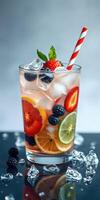 Refreshing fruit beverage with ice and berries served in a glass on a dark surface photo