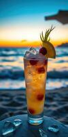 Refreshing cocktail with raspberries and lemon at sunset by the beach photo