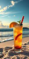 Colorful tropical cocktail on sandy beach with ocean waves and sunset in the background photo