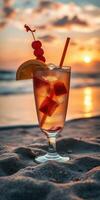 Sunset beach cocktail with fruit garnish against a vibrant sky and ocean photo