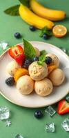 Delicious fruit ice cream dessert featuring fresh berries, bananas, and mint on a green background photo