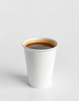 Hot coffee in a disposable cup on a plain background, evoking a sense of warmth and comfort in daily life photo