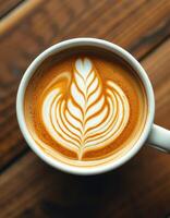 Beautiful latte art with intricate design served in a white cup on a wooden table photo
