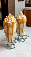 Creamy desserts with silky caramel drizzle on top served in elegant glasses at a stylish cafe photo