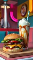 Delicious cheeseburger and creamy caramel milkshake served in a vibrant diner setting during the day photo
