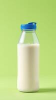 Fresh milk in a clear bottle against a vibrant green backdrop ready for consumption photo