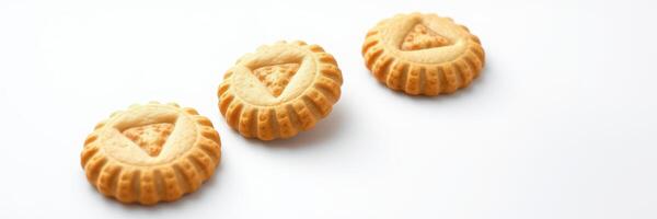 Sweet round cookies with triangle shapes arranged in a line on a white background photo