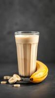 Refreshing banana smoothie with fresh banana slices on a dark surface photo