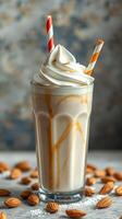 Creamy almond milkshake topped with whipped cream and caramel drizzles in a tall glass with colorful straws photo