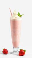 Delicious strawberry milkshake topped with whipped cream and mint leaf served in a tall glass photo