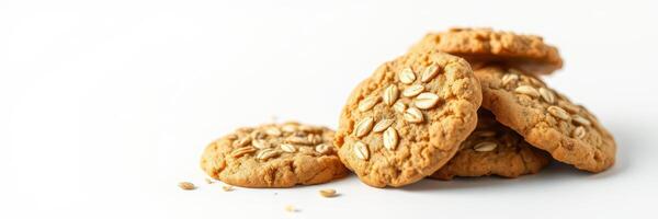 Oatmeal cookies placed on a white surface with scattered oats nearby photo
