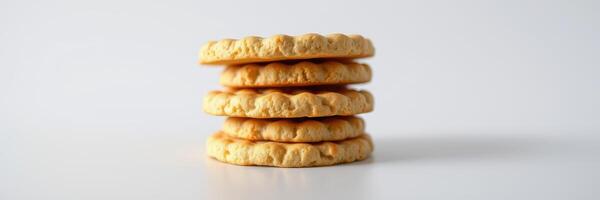 Layered cookies stacked neatly on a plain surface ready to be enjoyed with beverages or as a snack photo