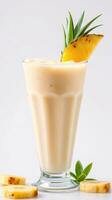 Refreshing pineapple smoothie served in a tall glass with tropical garnishes during a sunny summer afternoon photo