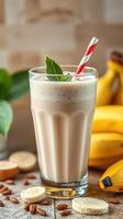 Refreshing banana smoothie with mint served in a tall glass alongside fresh bananas and coffee beans photo