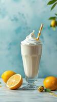 Refreshing lemon-flavored milkshake topped with whipped cream and a straw on a pastel background photo