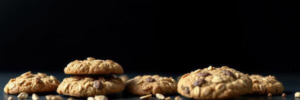 Freshly baked cookies arranged on a dark surface with scattered oats, ideal for an inviting dessert display photo