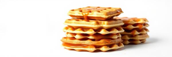 Delicious stack of waffles drizzled with syrup on a plain background for breakfast or dessert photo