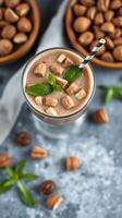Creamy chocolate drink topped with mint leaves and chocolate pieces at a cozy setting photo