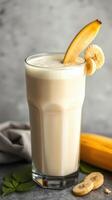 Delicious smoothie prepared with ripe bananas, creamy yogurt, and fresh ingredients in a glass setting photo