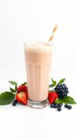 Delicious strawberry and berry smoothie served in a tall glass with fresh berries and mint leaves photo